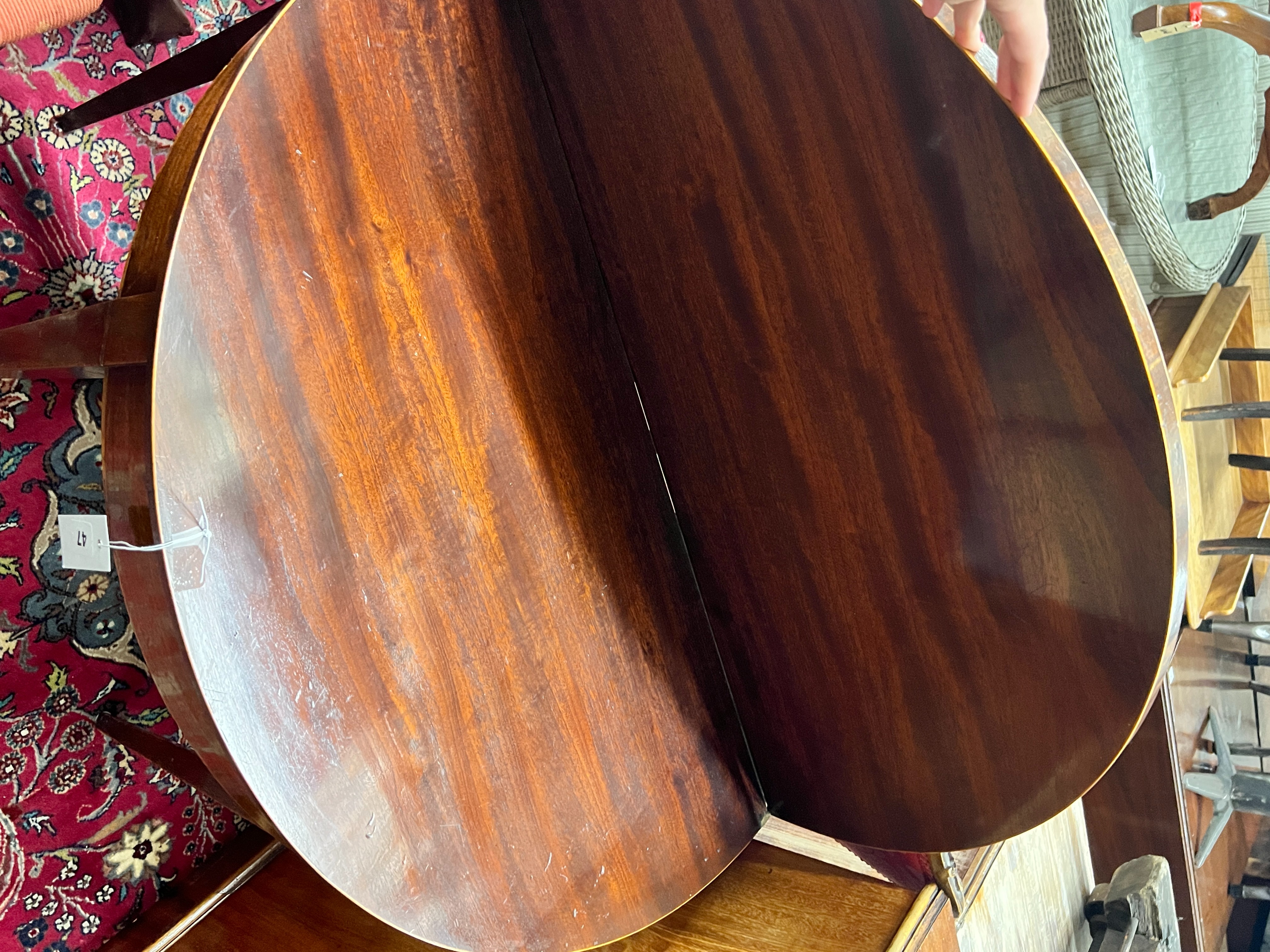 A George III mahogany D-shaped folding tea table, width 92cm, depth 46cm, height 73cm